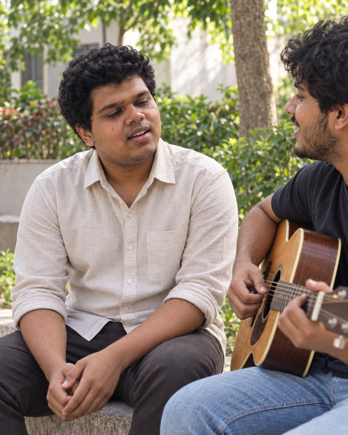 Conceptual candid-style portrait of recording artist Yethikrishna R singing beside an acoustic guitarist in a courtyard setting.